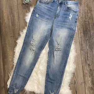 Women’s light washed, distressed, skinny jeans with front and back pockets